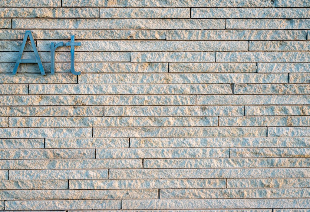 Close-up of a textured brick wall with the word 'Art' in Overland Park, Kansas.